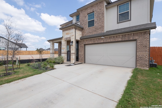 view of front of home featuring a garage and a front yard