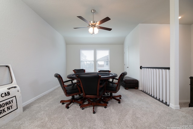 carpeted dining area featuring ceiling fan and vaulted ceiling