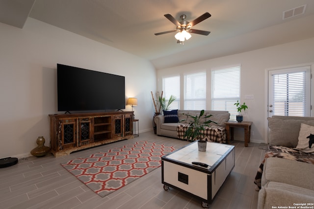 living room with wood-type flooring, lofted ceiling, and ceiling fan