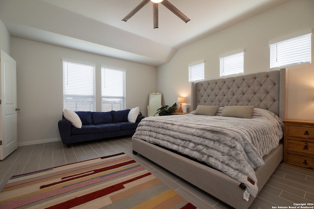 bedroom featuring multiple windows, vaulted ceiling, and ceiling fan