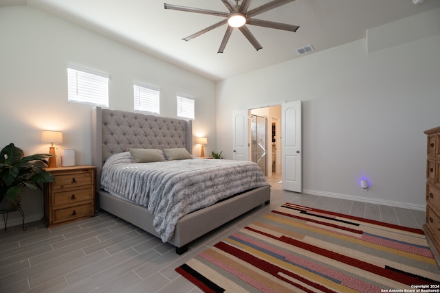 bedroom featuring ceiling fan, vaulted ceiling, and wood-type flooring