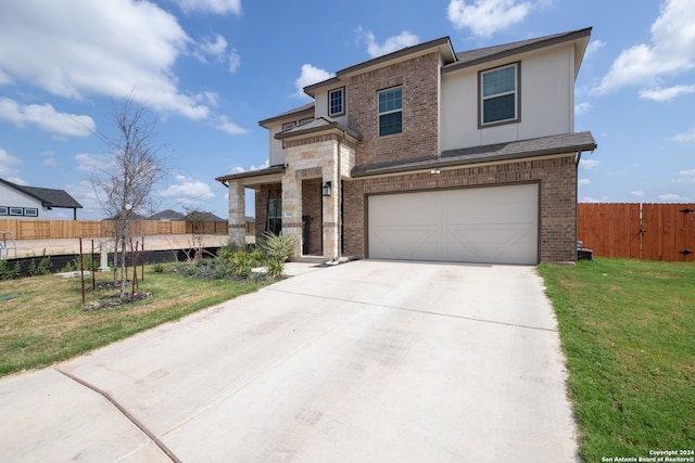 view of front of property featuring a front yard and a garage