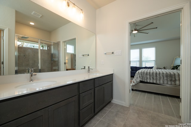 bathroom with vanity, ceiling fan, tile patterned floors, and a shower with shower door