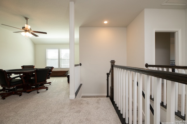 carpeted office space featuring ceiling fan