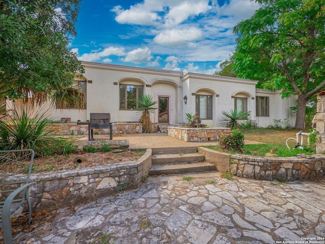 mediterranean / spanish-style home featuring a patio area