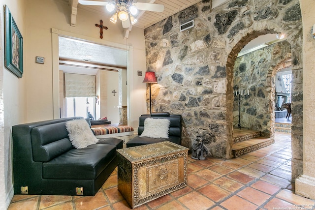 living room with ceiling fan and plenty of natural light