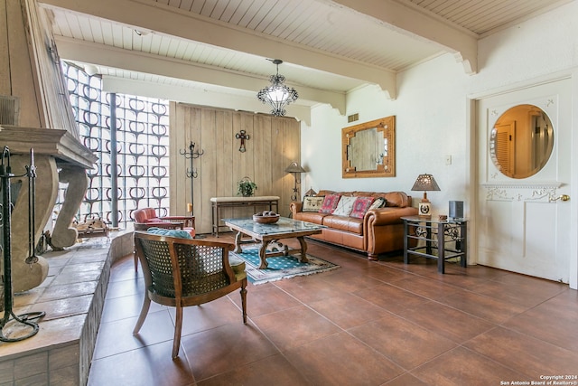 tiled living room with beamed ceiling, a chandelier, and wooden ceiling