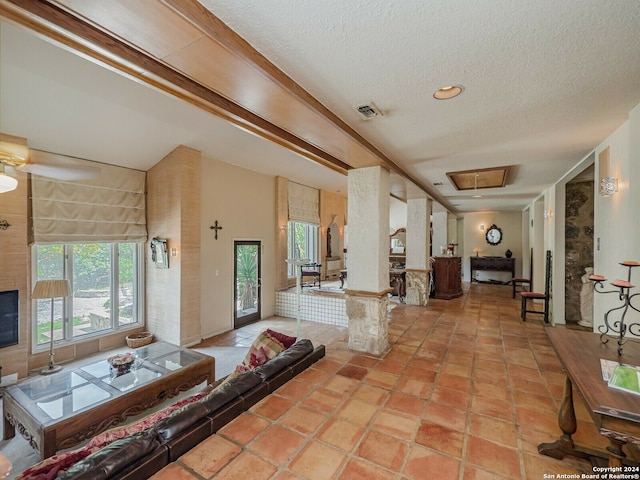 living room with a textured ceiling and light tile patterned flooring