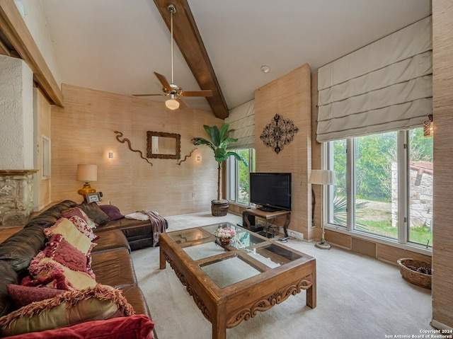 living room featuring ceiling fan, vaulted ceiling with beams, and light carpet