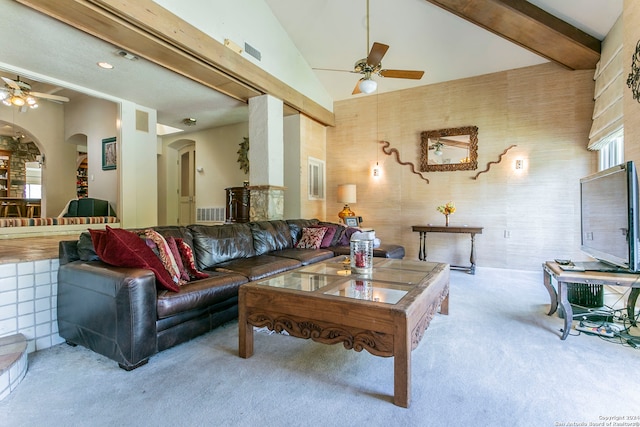 carpeted living room with high vaulted ceiling, beam ceiling, and ceiling fan