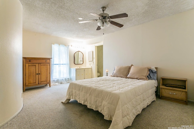 carpeted bedroom with ceiling fan and a textured ceiling