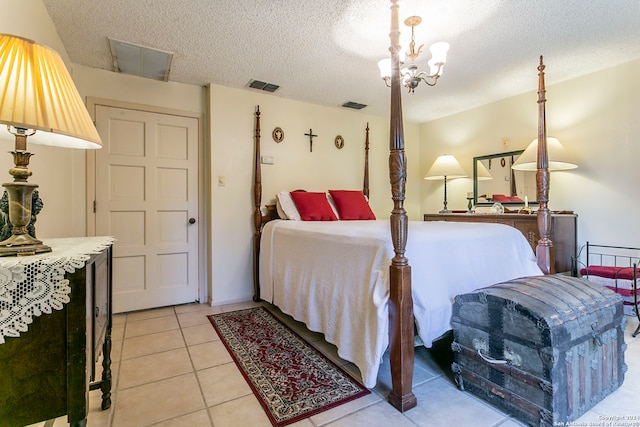 tiled bedroom with a textured ceiling and a chandelier