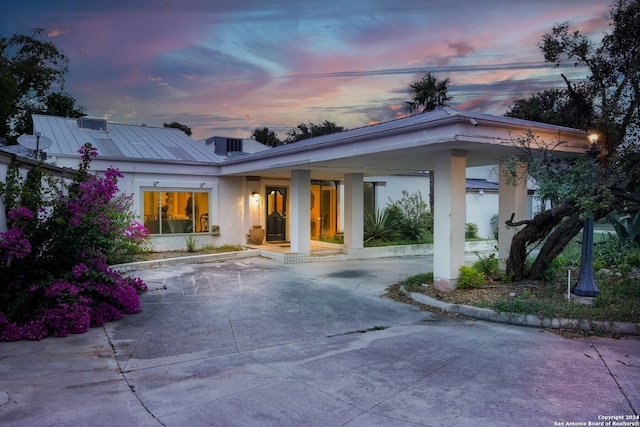 back house at dusk with a patio area