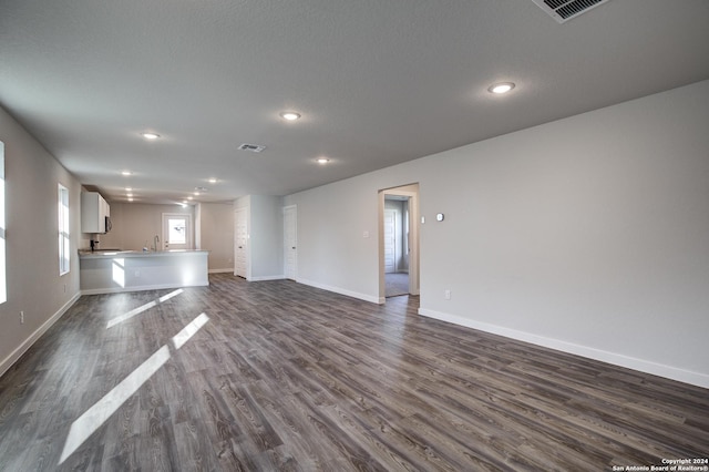 2544 Solon Ln, Seguin, TX 78155 - unfurnished living room featuring baseboards, visible vents, recessed lighting, and a sink