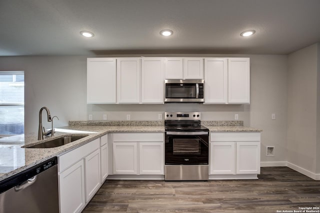 2544 Solon Ln, Seguin, TX 78155 - kitchen with recessed lighting, light stone counters, a sink, appliances with stainless steel finishes, and white cabinetry