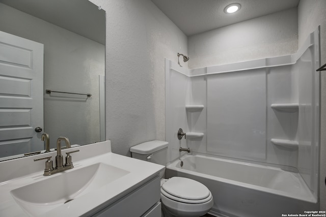 full bathroom with toilet, bathtub / shower combination, a textured ceiling, and vanity