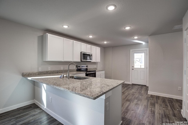 2544 Solon Ln, Seguin, TX 78155 - kitchen with dark wood-style flooring, a sink, white cabinetry, baseboards, and appliances with stainless steel finishes