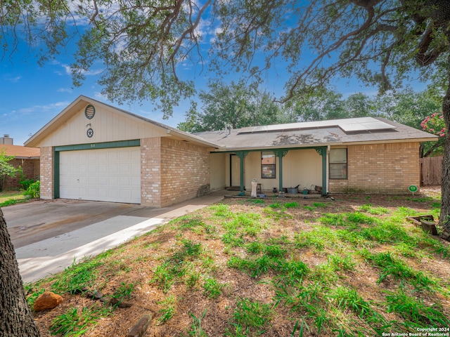 ranch-style home featuring a garage and covered porch