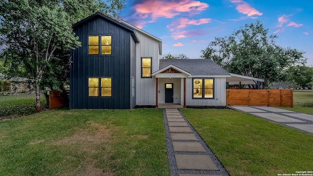 modern farmhouse style home featuring a yard