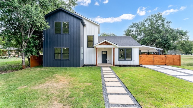 modern inspired farmhouse with a front lawn