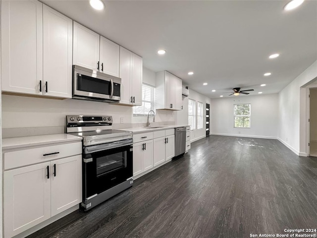 kitchen with ceiling fan, stainless steel appliances, and white cabinetry