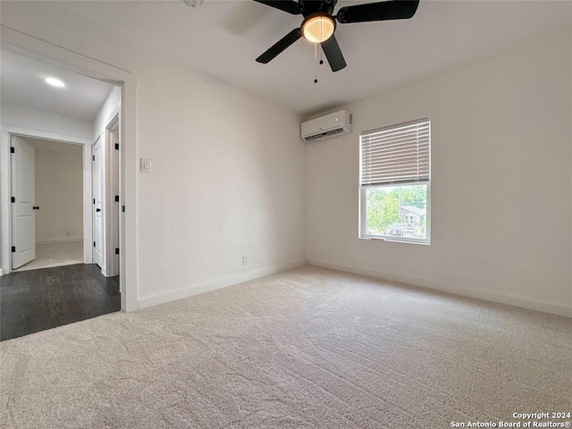 carpeted empty room with an AC wall unit and ceiling fan