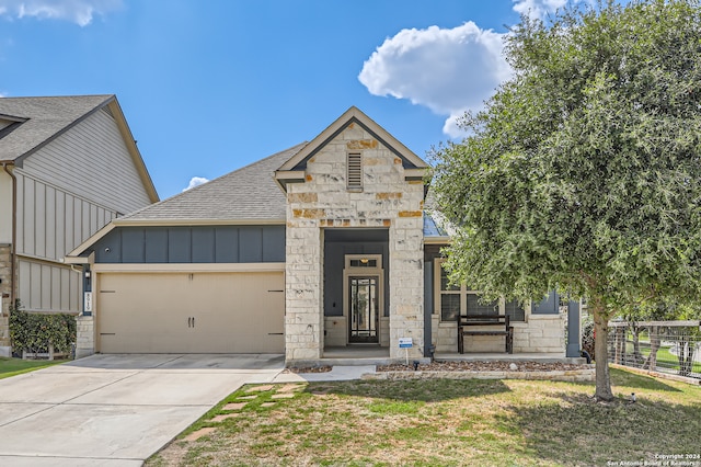 view of front of home featuring a front yard and a garage