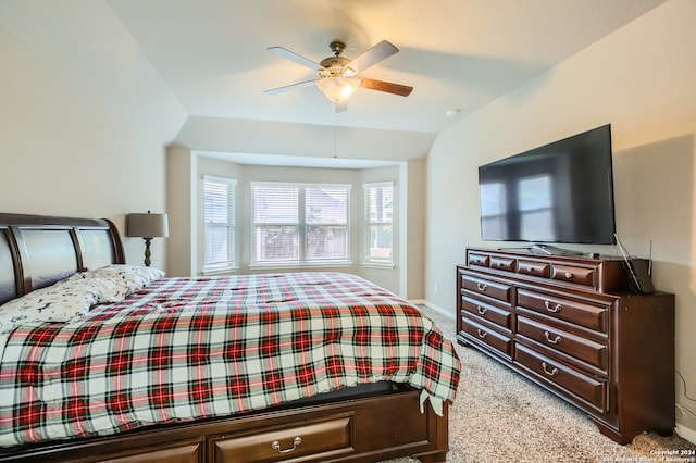 carpeted bedroom with ceiling fan and vaulted ceiling