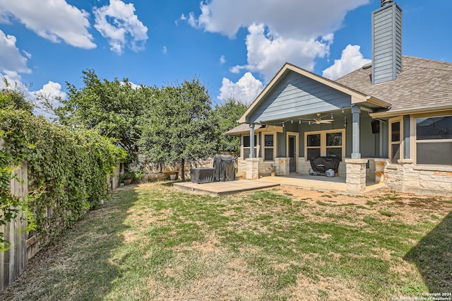 view of yard with a patio and ceiling fan