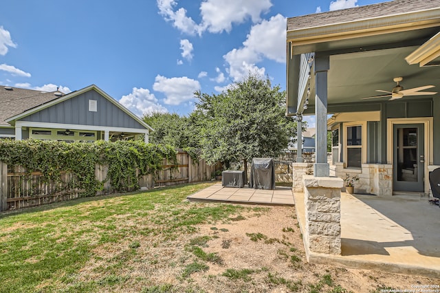 view of yard with ceiling fan and a patio area