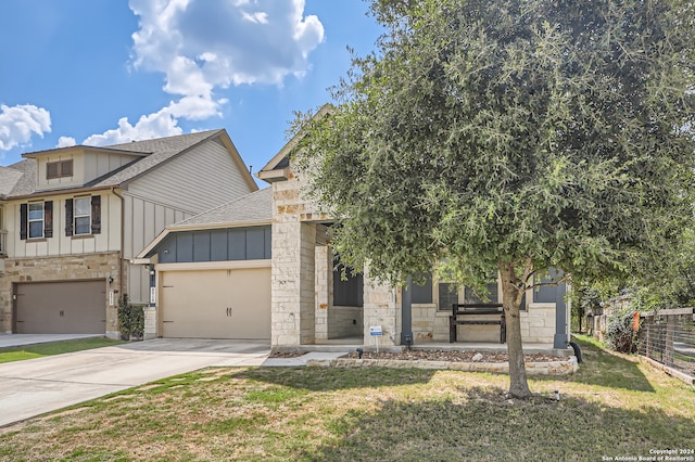 view of front of property featuring a front yard and a garage