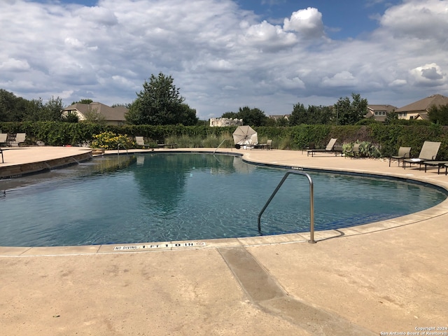 view of swimming pool featuring a patio area