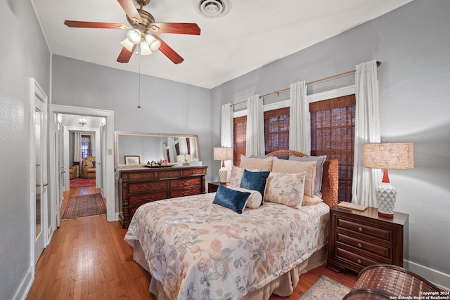 bedroom with ceiling fan and light hardwood / wood-style floors