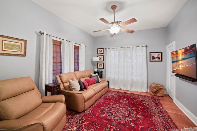 living room featuring hardwood / wood-style floors and ceiling fan