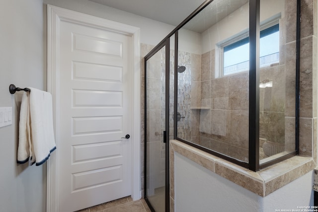 bathroom featuring tile patterned floors and an enclosed shower