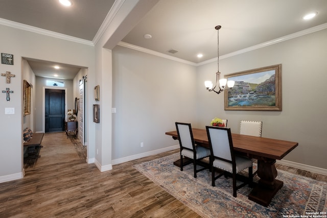 dining space with crown molding, dark hardwood / wood-style floors, and a notable chandelier