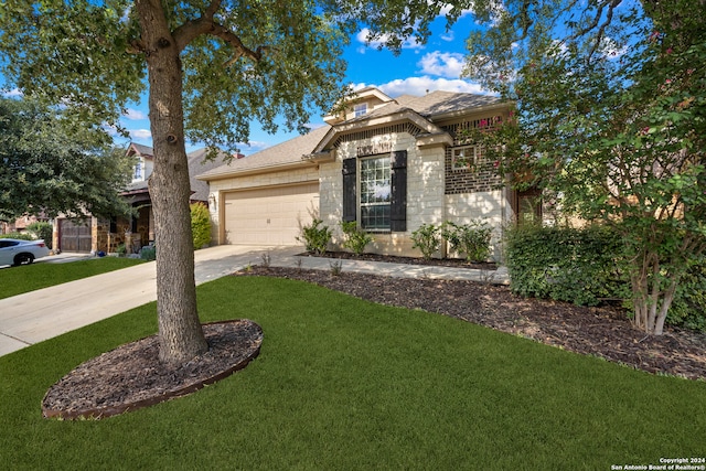 view of front of property with a garage and a front lawn