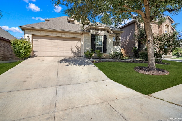 single story home with a garage and a front lawn