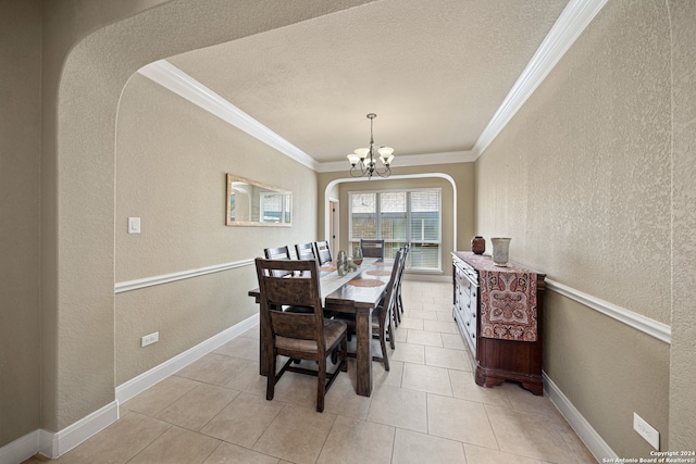 dining space with a textured ceiling, ornamental molding, an inviting chandelier, and light tile patterned floors