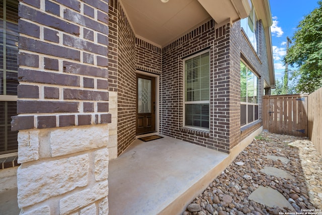 view of exterior entry featuring a patio area