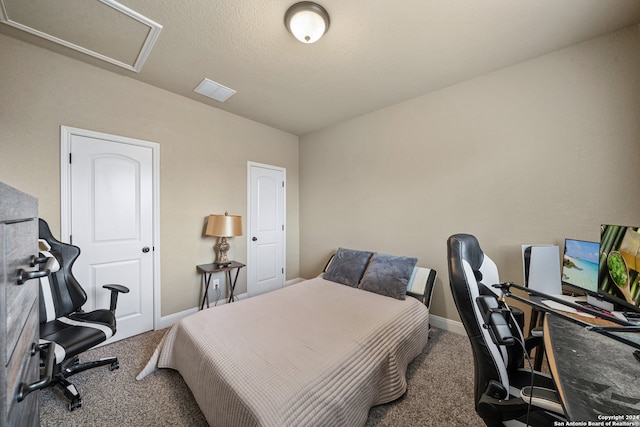 carpeted bedroom featuring a textured ceiling