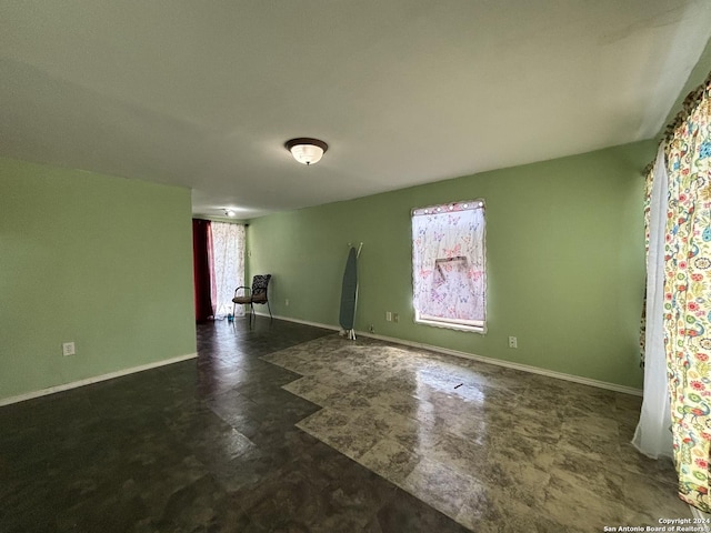 unfurnished room featuring baseboards