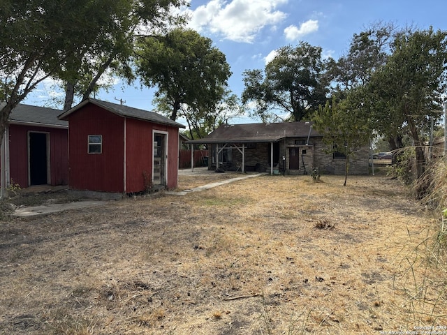 back of property featuring an outdoor structure