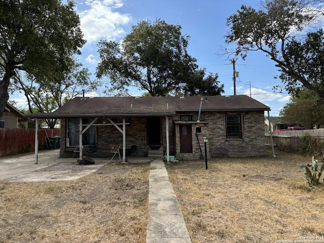 view of front facade with brick siding and fence
