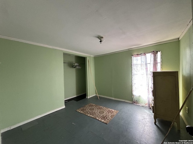 unfurnished bedroom featuring a closet, ornamental molding, and baseboards