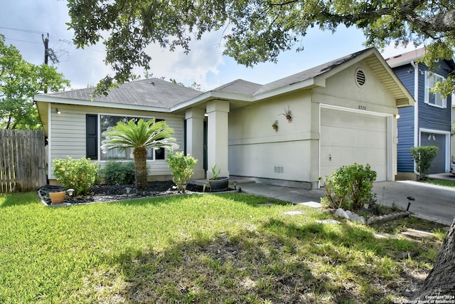 ranch-style home with a garage and a front yard