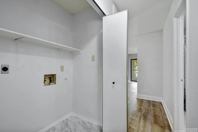 clothes washing area featuring light wood-type flooring, washer hookup, and electric dryer hookup