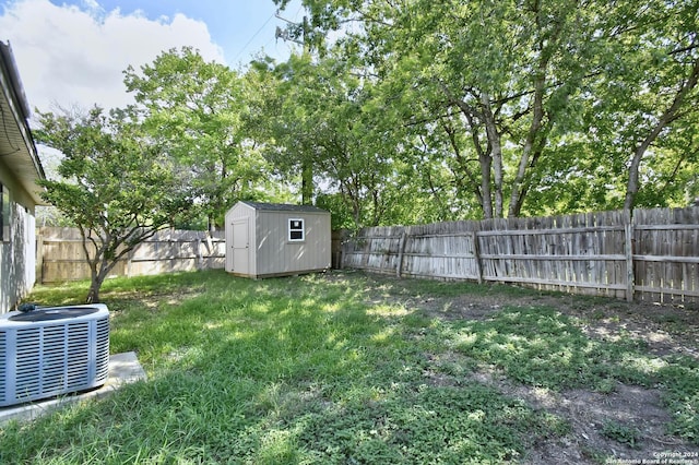 view of yard with a storage unit and central AC unit