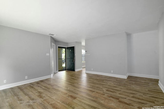 empty room with hardwood / wood-style floors