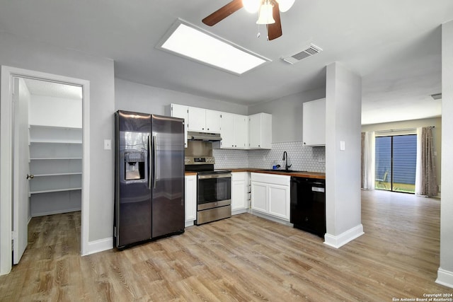 kitchen with light hardwood / wood-style floors, sink, white cabinetry, black appliances, and ceiling fan